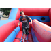 Teenage boy jumping on an inflatable 