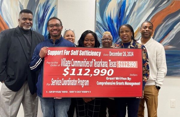 A group holding a large check.